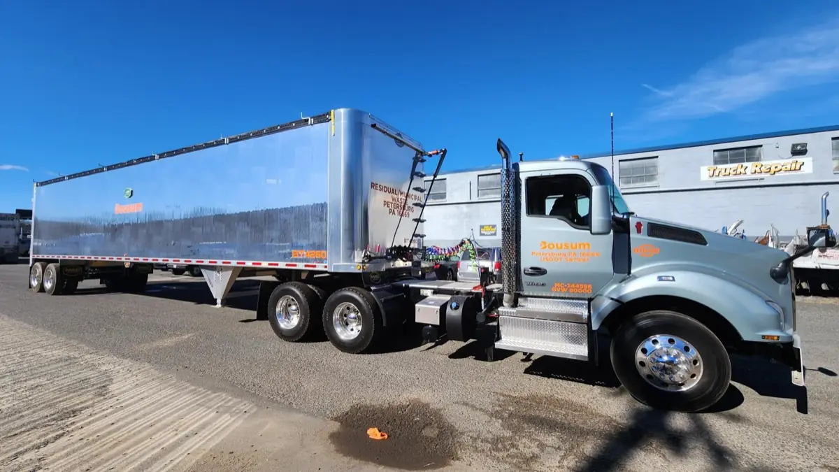 Bousum Kenworth daycab and polished aluminum transfer trailer